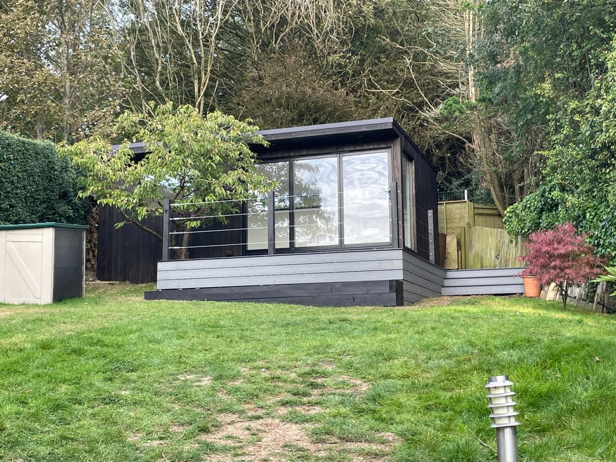 Black-clad garden office at the top of a sloping Brighton garden