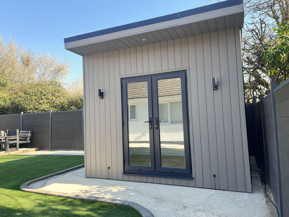 Grey composite-clad home gym garden room with French doors