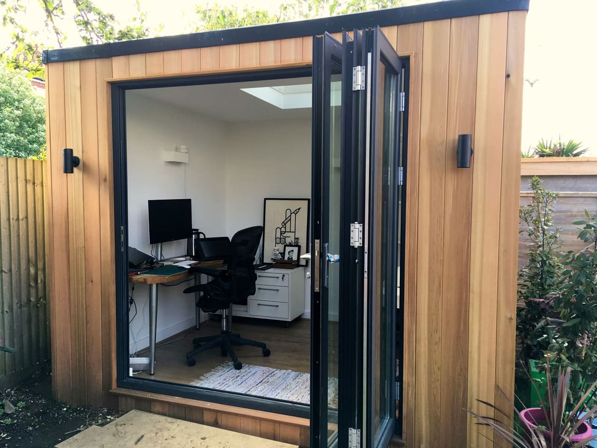 Garden office interior with desk, shelving and skylight