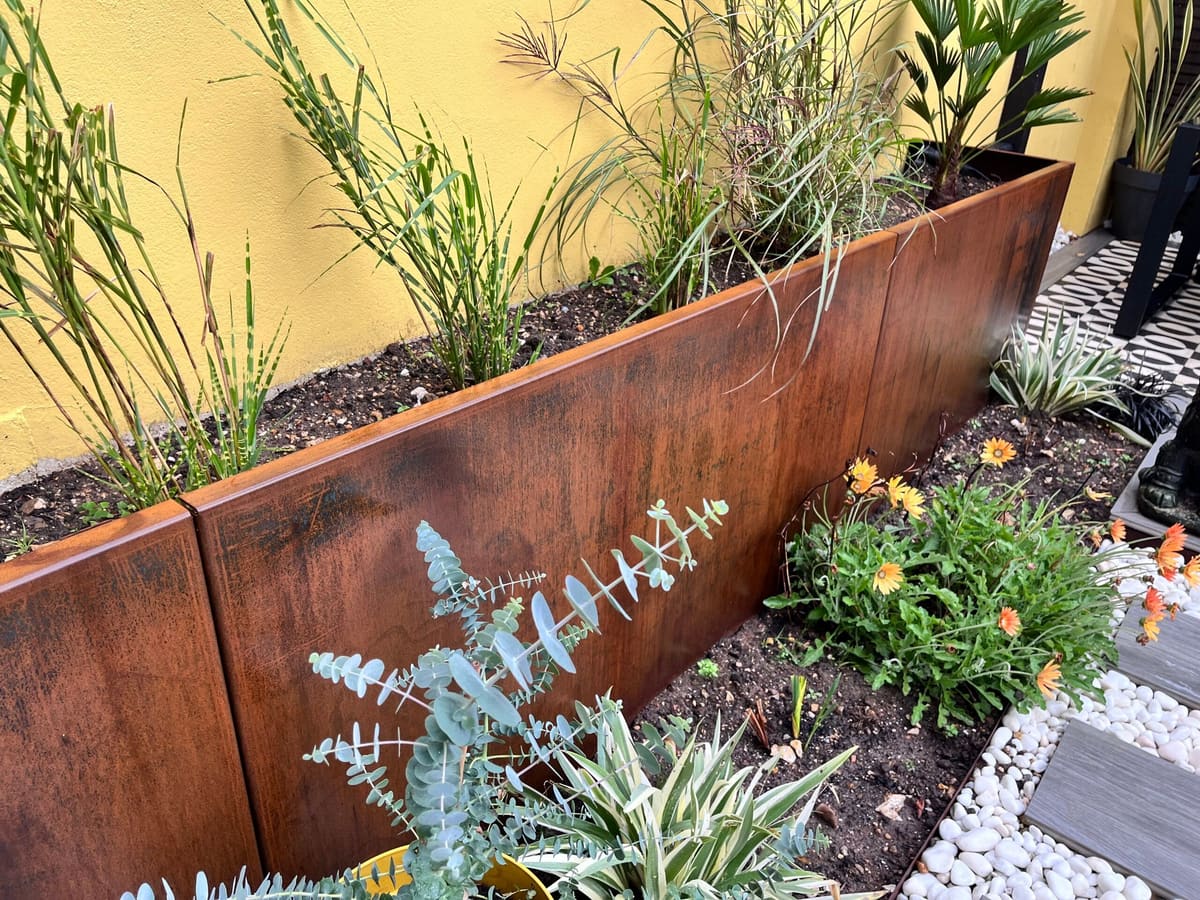 Corten steel planter with grasses and flowers