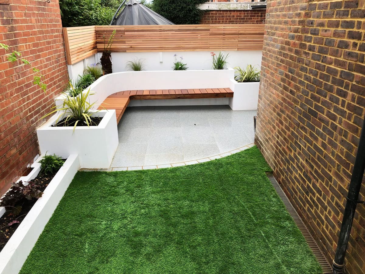 Rendered planters, curved bench and lawn in a courtyard garden