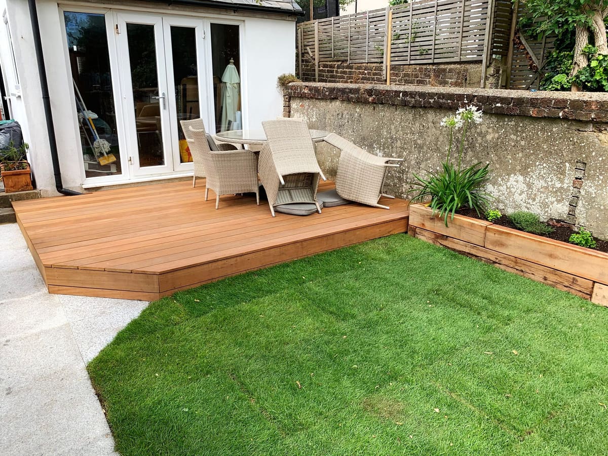 Hardwood deck and lawn outside a house